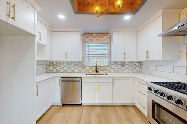 a kitchen with stainless steel appliances granite countertop a stove and a sink