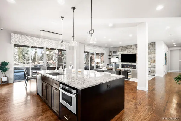 a large kitchen with kitchen island a sink table and chairs