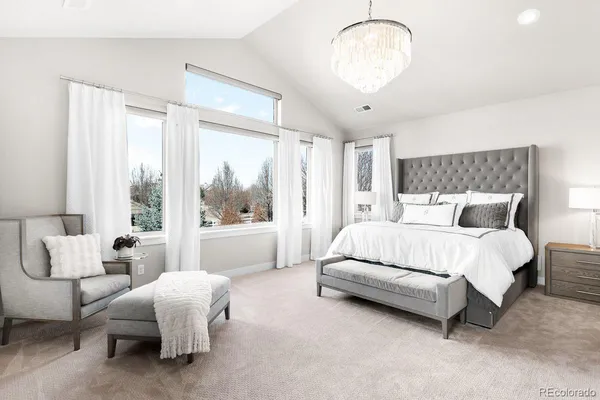 a bedroom with bed and a large window