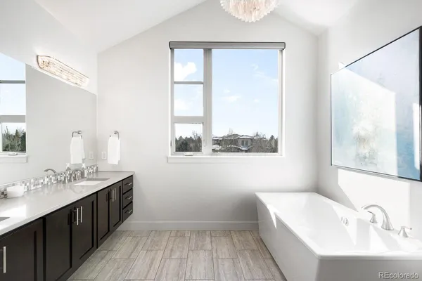 a bathroom with a sink a mirror and a window
