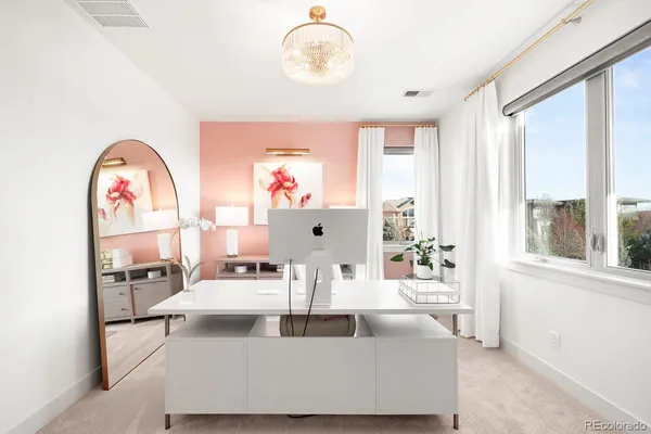 a living room with stainless steel appliances kitchen island a wooden floor and a view of kitchen