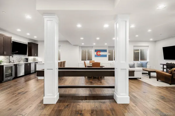 a kitchen with stainless steel appliances kitchen island granite countertop a stove a sink a microwave a dining table and chairs