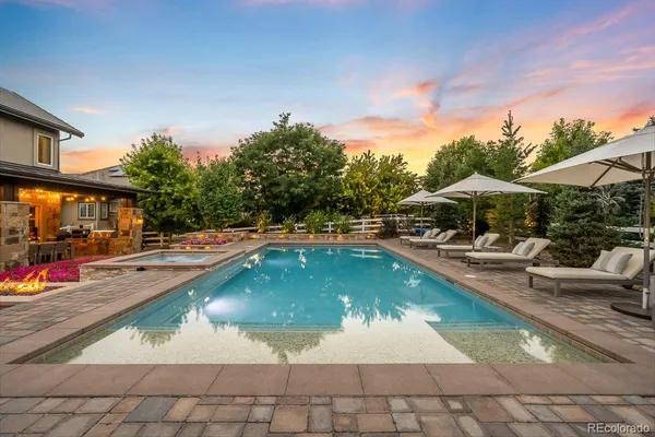 a view of a swimming pool with a bench in patio