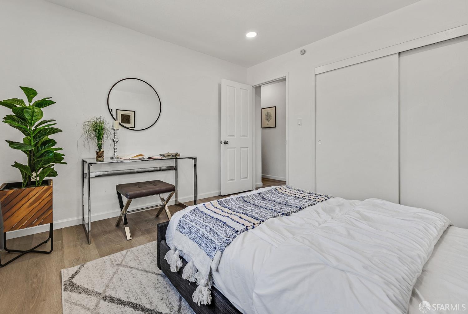 3138 Flannery Road San Pablo, CA 94806 - Photo 20 of 38 a bedroom with a bed a desk and chair with wooden floor