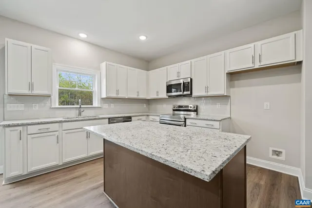 a kitchen with stainless steel appliances granite countertop a sink stove and cabinets