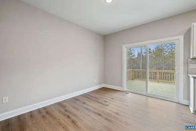 a spacious bedroom with a large bed couch and a window