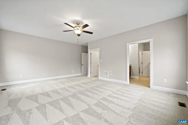a bathroom with a granite countertop double vanity sink and mirror