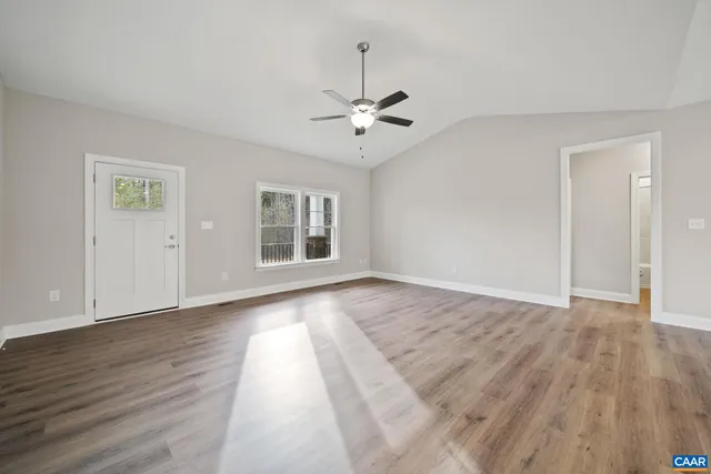 a living room with furniture potted plant and a flat screen tv