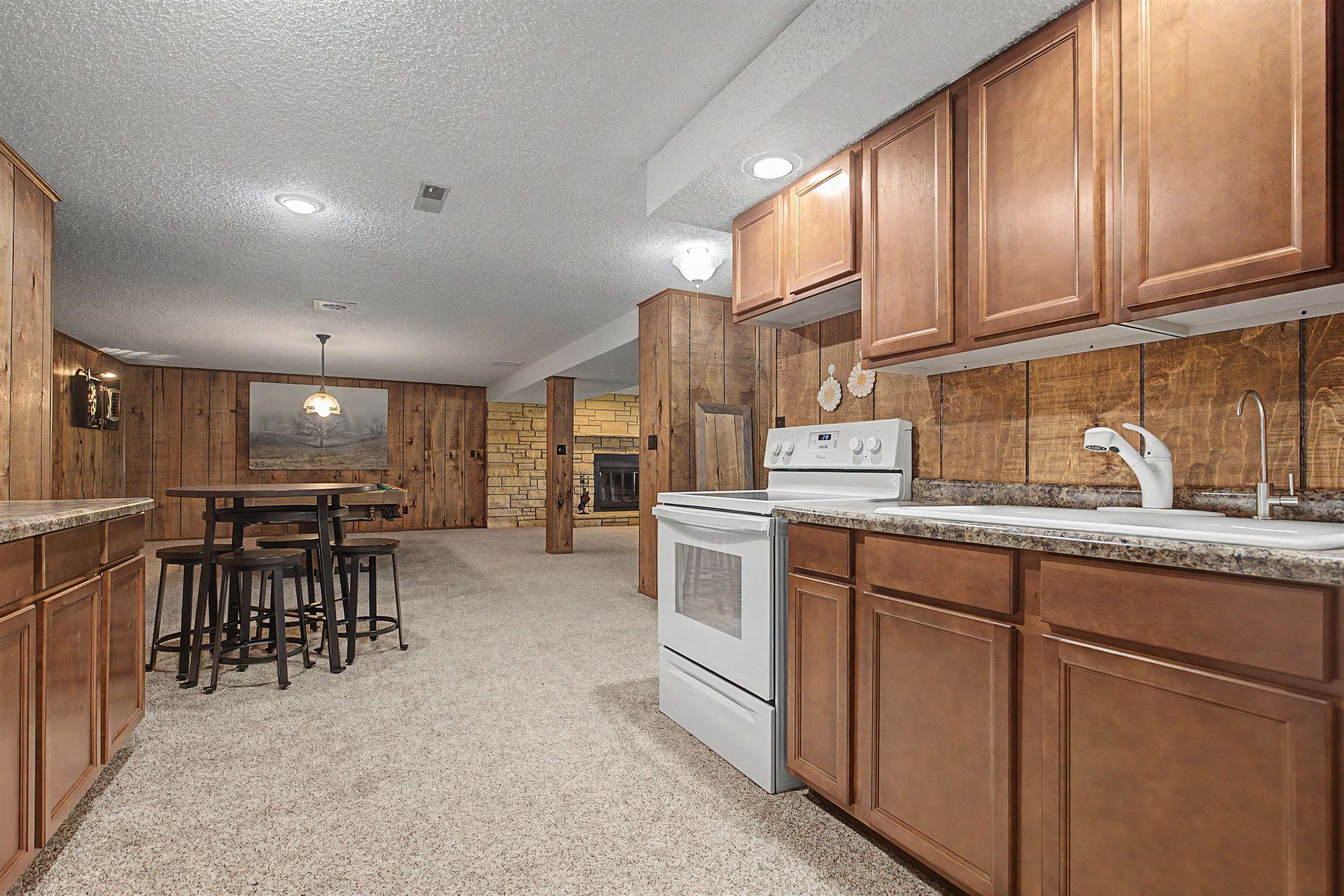 17380 Corbett Road Mount Carroll, IL 61053 - Photo 24 of 65 a kitchen with kitchen island granite countertop a table chairs sink and cabinets