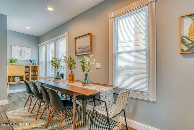 a view of a dining room with furniture and a window