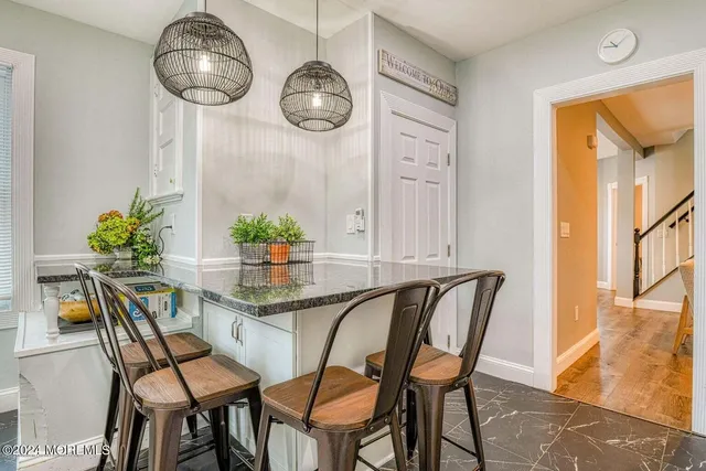 a dining room with furniture and wooden floor