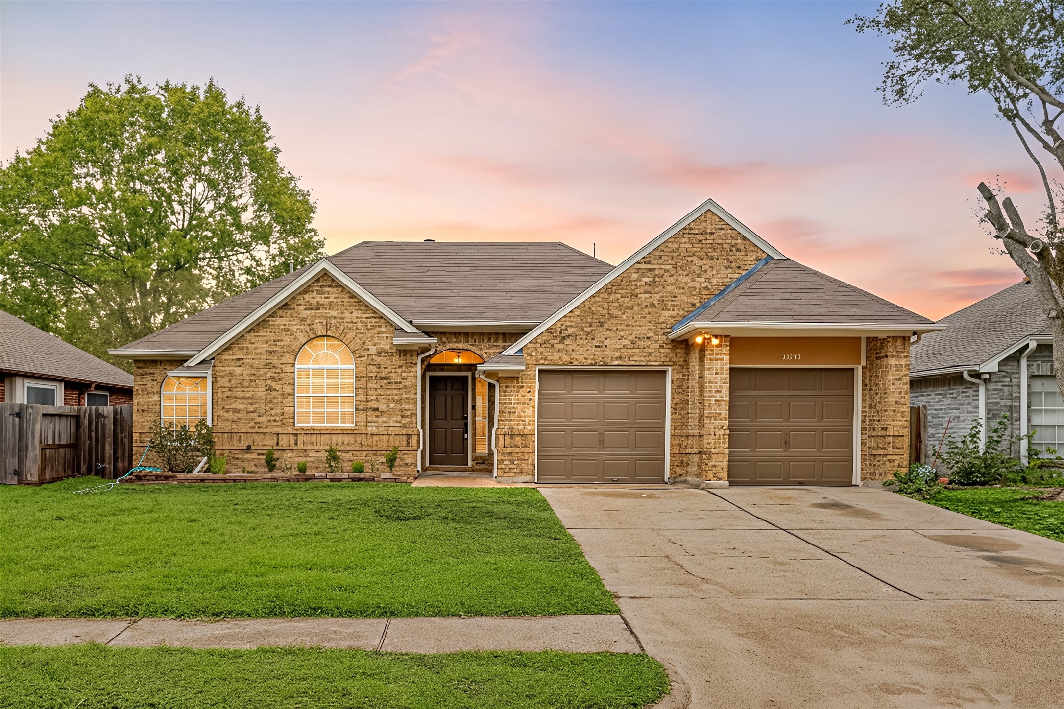 a front view of a house with a garden and yard