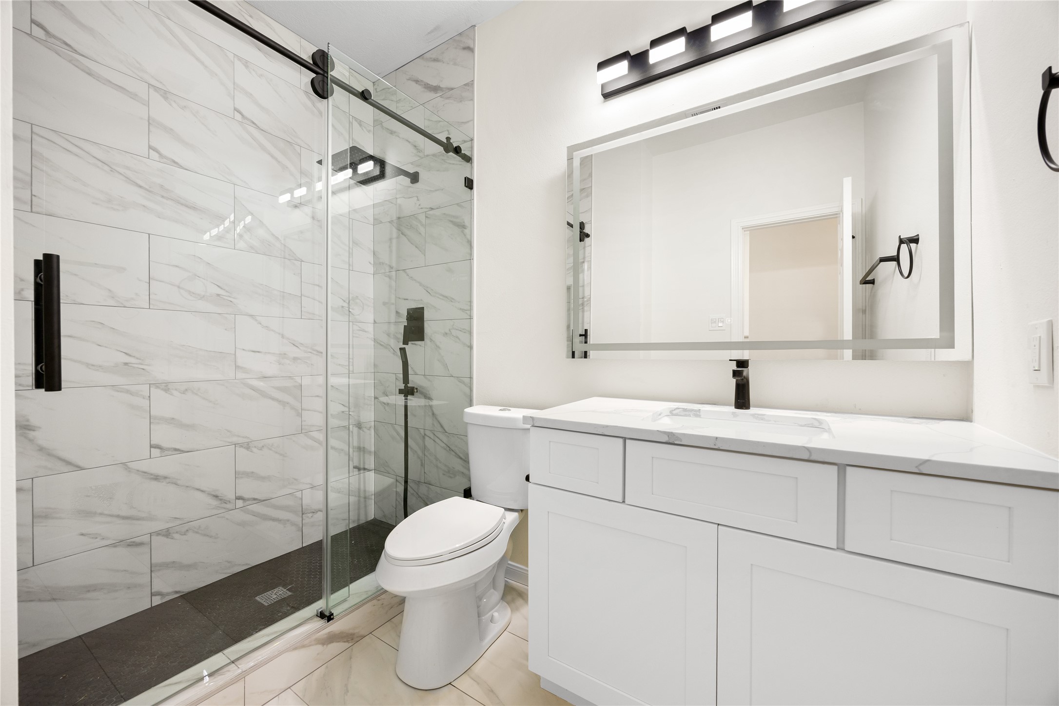 13735 Sablegarden Lane Houston, TX 77014 - Photo 16 of 20 a bathroom with a sink a toilet and shower