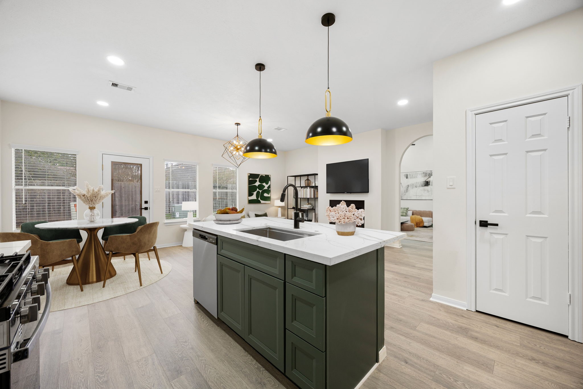 13735 Sablegarden Lane Houston, TX 77014 - Photo 6 of 20 a kitchen with a sink a stove and chairs