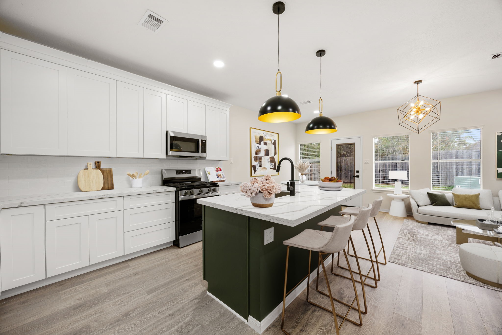 13735 Sablegarden Lane Houston, TX 77014 - Photo 7 of 20 a kitchen with stainless steel appliances granite countertop a stove a sink dishwasher a dining table and chairs with wooden floor