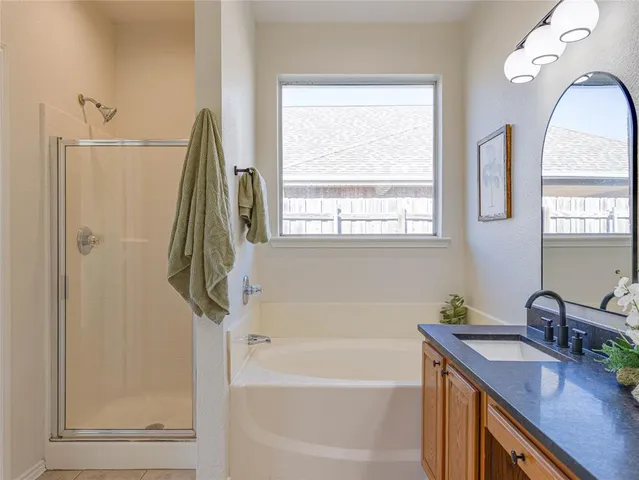 a bathroom with a tub sink and a window