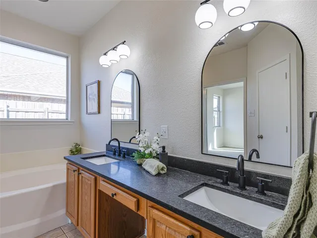 a bathroom with a double vanity sink and a mirror