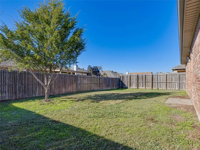 a view of a backyard with a large trees