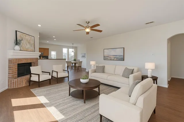 a living room with furniture a fireplace and a rug