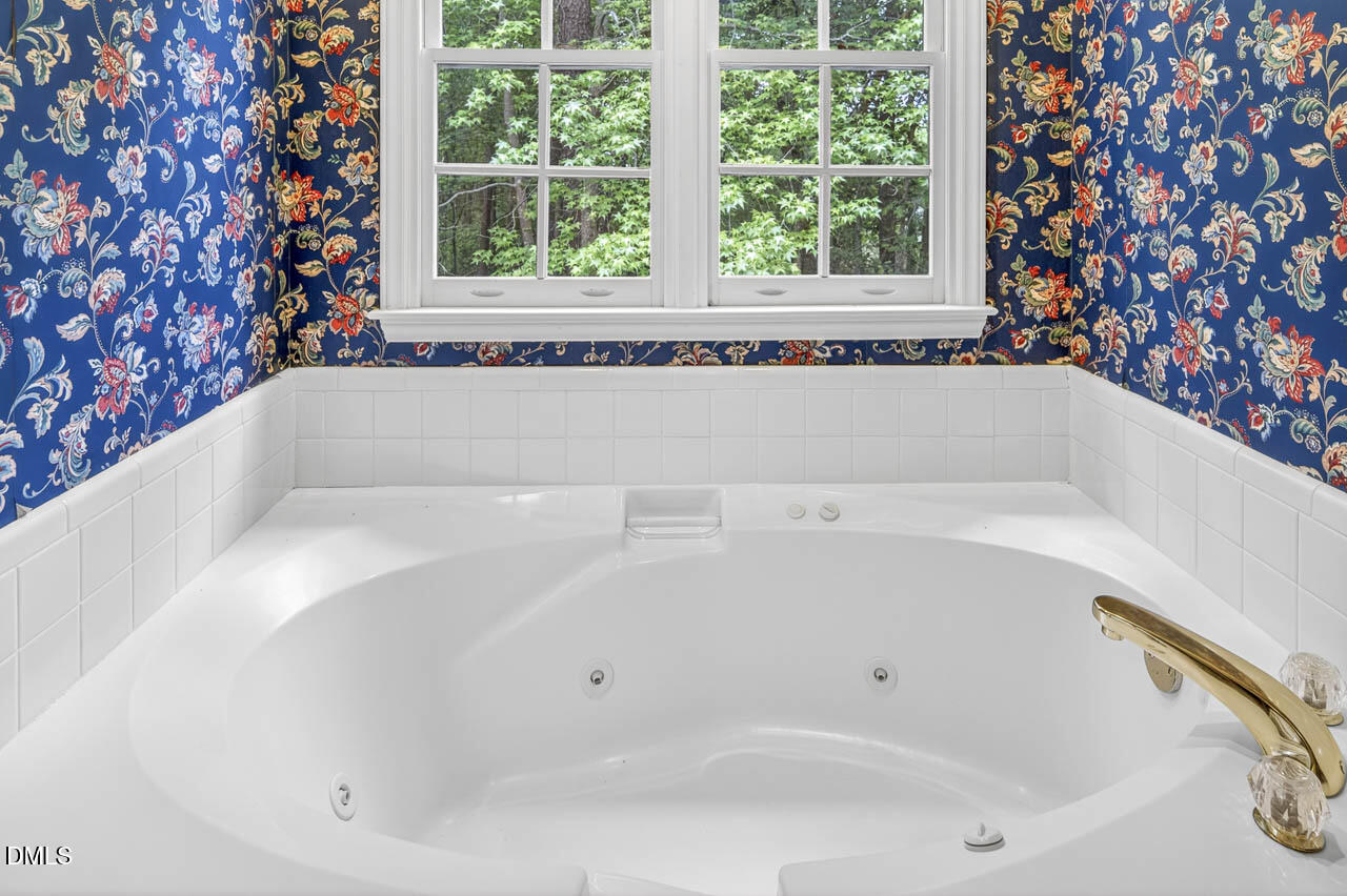 2209 Lodestar Drive Raleigh, NC 27615 - Photo 30 of 50 a white bath tub sitting in a bathroom next to a window