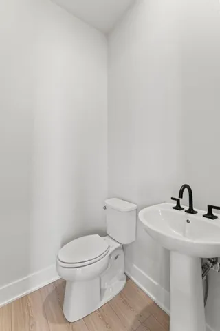 a bathroom with a sink a toilet and mirror