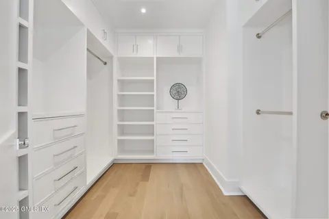 a view of walk in closet with empty racks