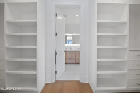 a view of walk in closet with empty racks