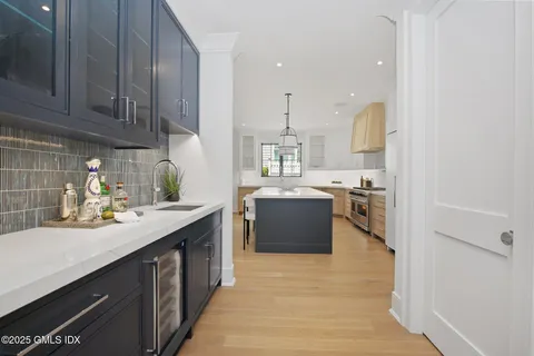 a kitchen with a sink cabinets and wooden floor