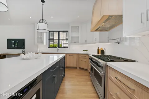 a kitchen with a sink stove and cabinets