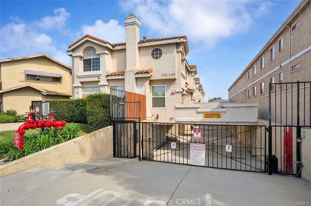 134 North Atlantic Boulevard, Unit B Alhambra, CA 91801 - Photo 18 of 18 a view of a white house with wooden fence and potted plants