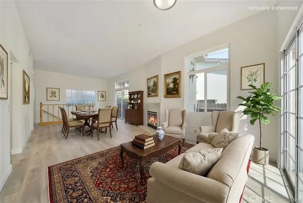 a living room with furniture potted plant and a window
