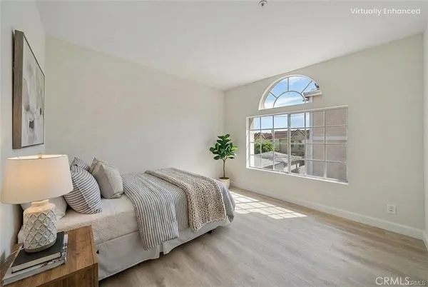 a spacious bedroom with a bed and a window
