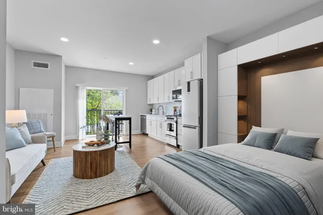 a bedroom with a large bed and a potted plant