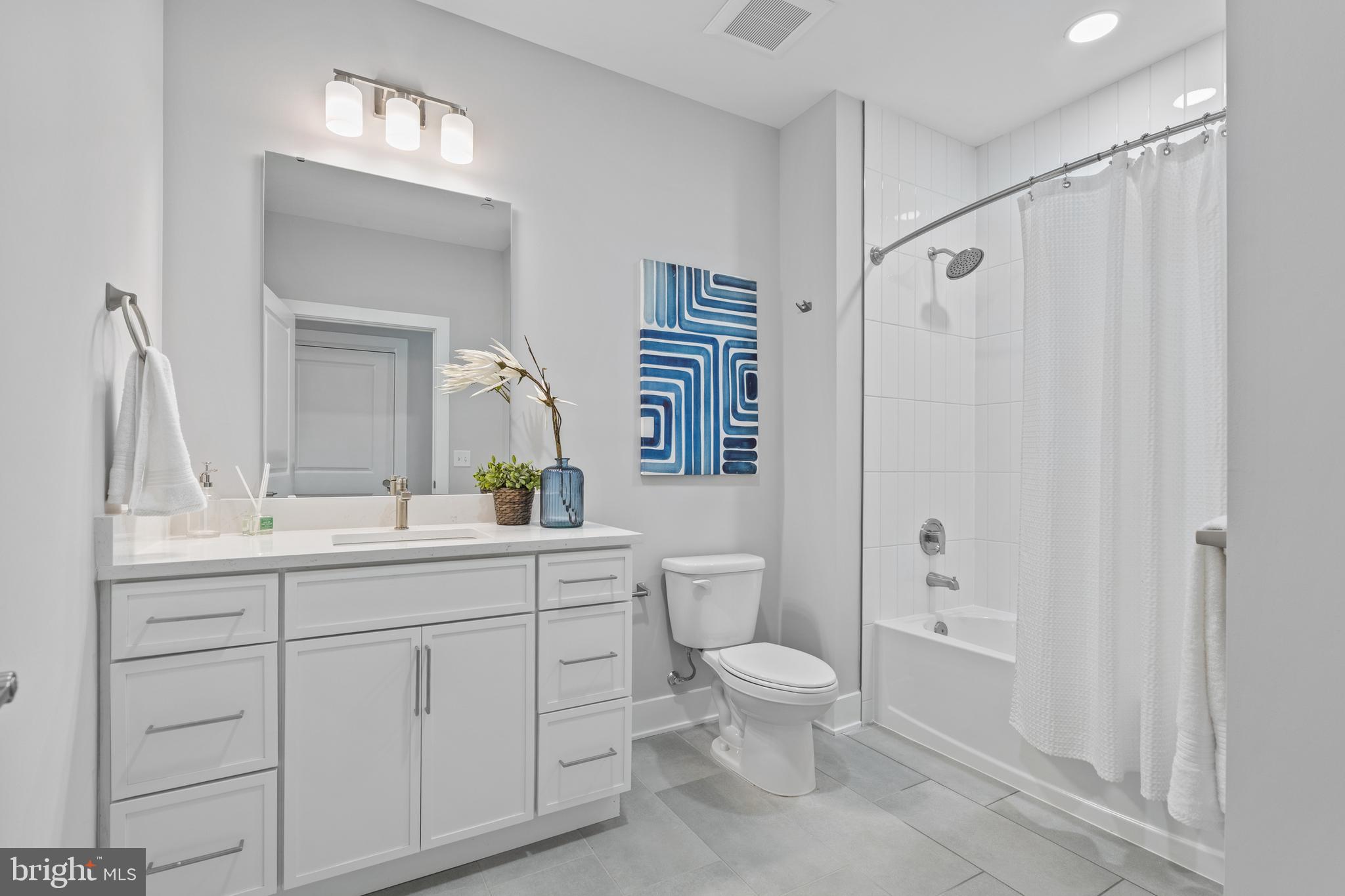 144 North Main Street Dublin, PA 18917 - Photo 12 of 40 a bathroom with a toilet a sink and a large mirror