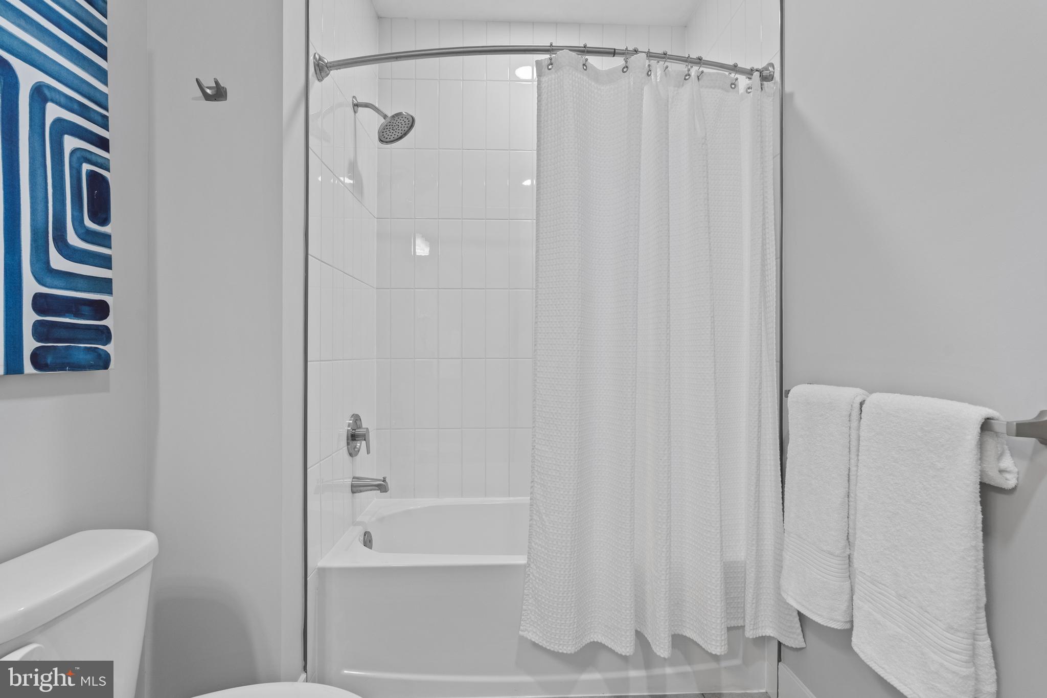 144 North Main Street Dublin, PA 18917 - Photo 13 of 40 a bathroom with a shower curtain and a toilet