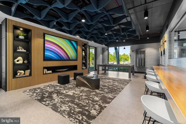 a living room with furniture pool table and a large window
