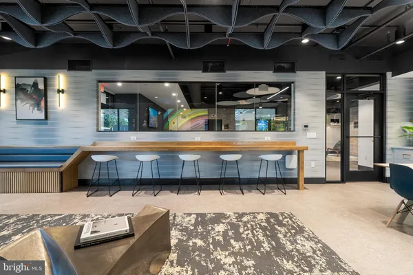 a bedroom with furniture and a large window