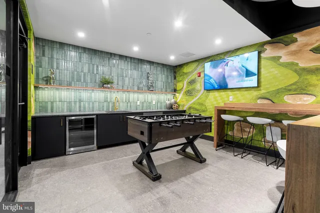 a room with furniture pool table and flat screen tv