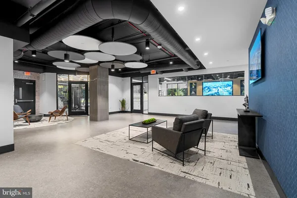 a living room with furniture and a ceiling fan