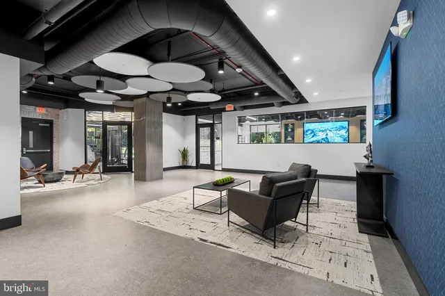 a living room with furniture and a ceiling fan
