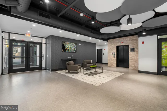 a view of a hall with dining room and wooden furniture