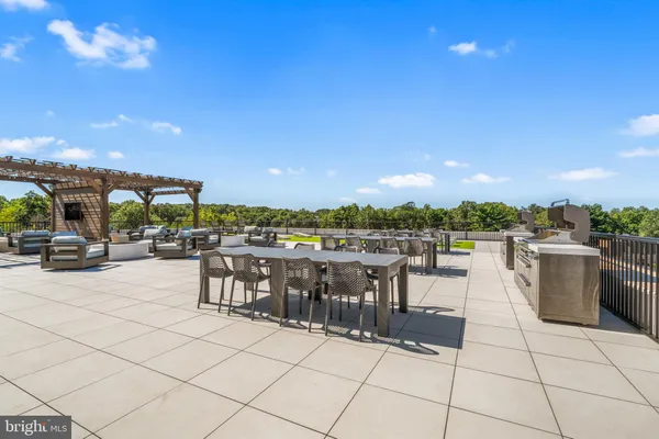 a view of a terrace with furniture and city view