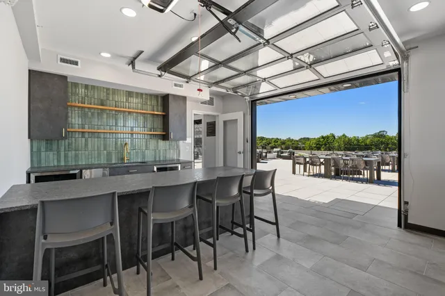 a dinning table and chairs in a room next to a window