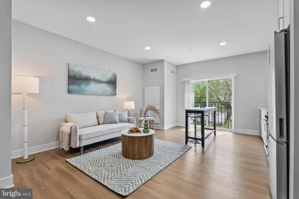a living room with furniture rug and a window