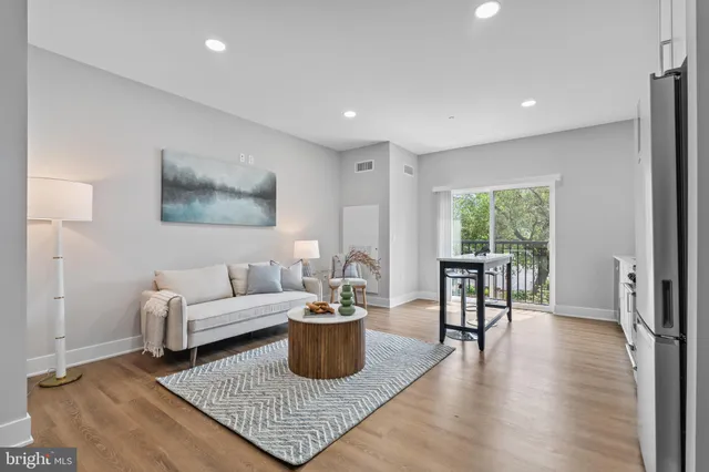 a living room with furniture rug and a window