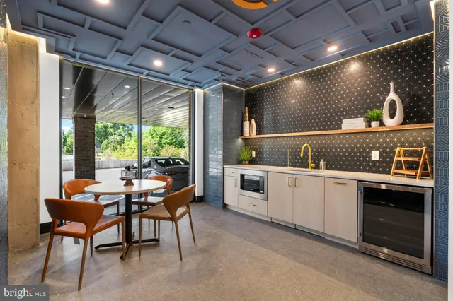 a open kitchen with stainless steel appliances granite countertop a sink a stove and a refrigerator