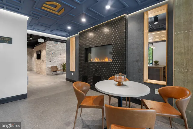 a outdoor dining space with a table and chairs