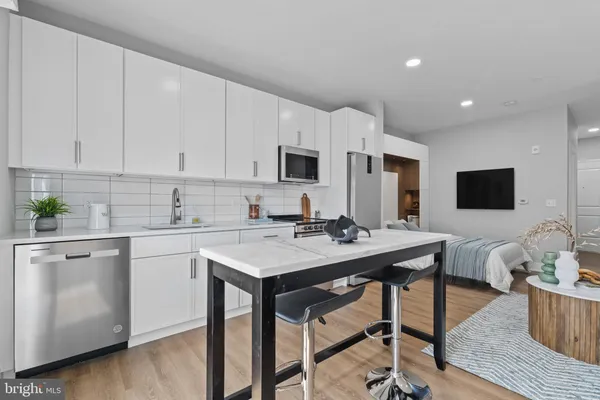 a kitchen with a stove a sink and a refrigerator