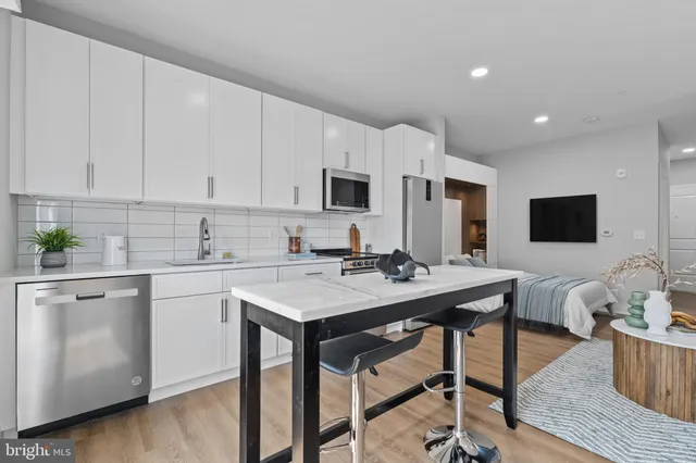 a kitchen with a stove a sink and a refrigerator