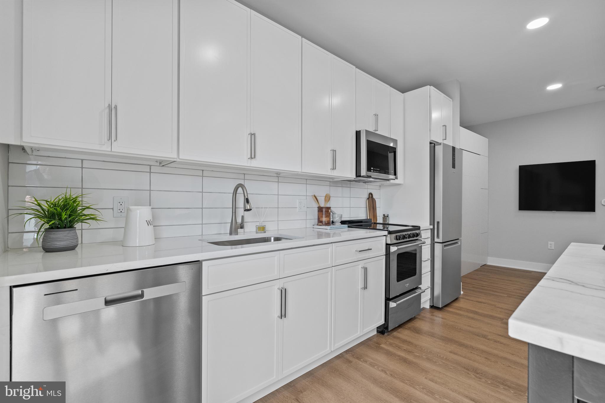 144 North Main Street Dublin, PA 18917 - Photo 7 of 40 a kitchen with stainless steel appliances white cabinets and sink